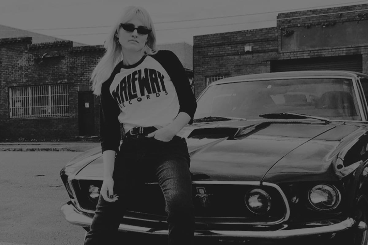 Beautiful girl with a Half Way Records tshirt and a car behind her