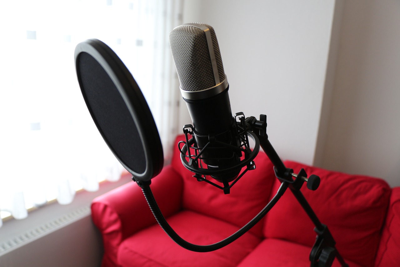 condenser microphone with a red sofa behind